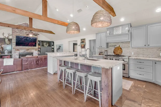 a kitchen with cabinets a sink and stainless steel appliances