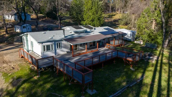 an aerial view of a house with a yard table and chairs