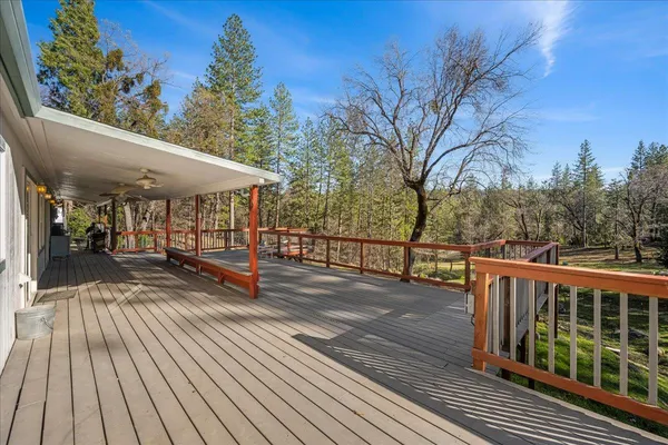 a view of a balcony with wooden floor and outdoor space