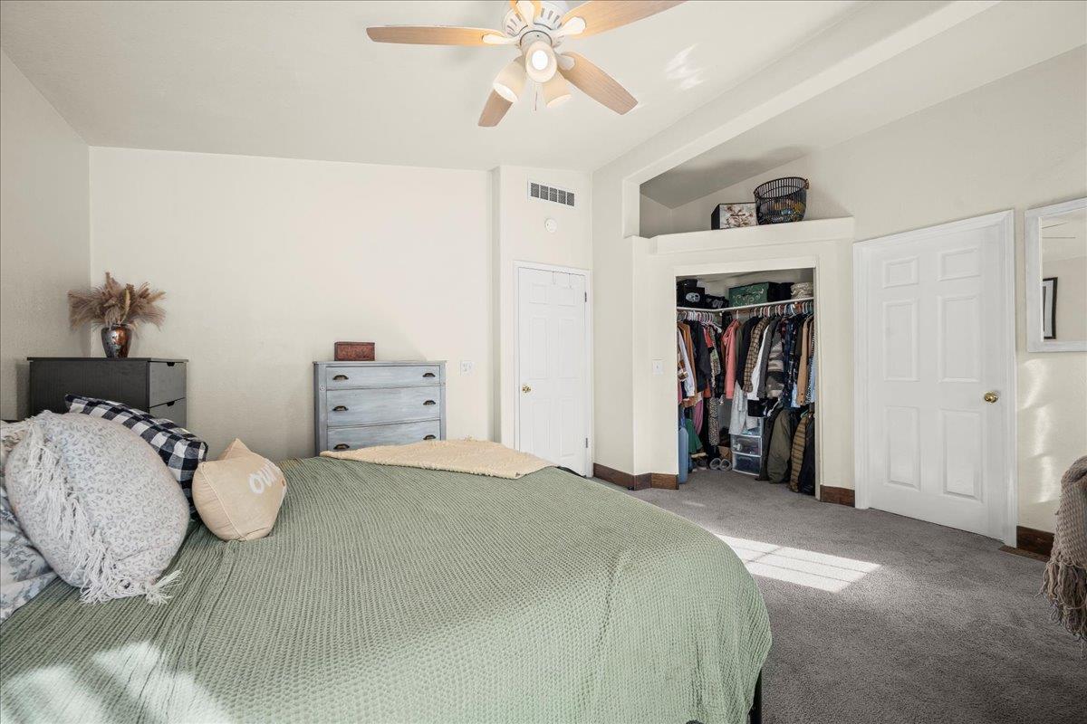 5351 Cosumnes Mine Road Somerset, CA 95684 - Photo 34 of 66 a bedroom with a bed and a chandelier