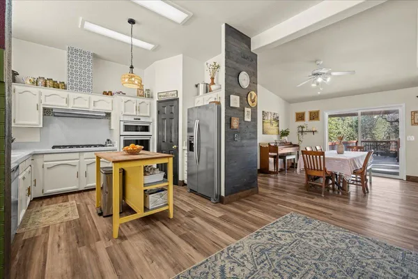 a view of kitchen and dining room with furniture window and wooden floor