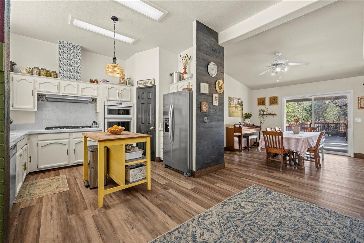 5351 Cosumnes Mine Road Somerset, CA 95684 - Photo 4 of 66 a view of kitchen and dining room with furniture window and wooden floor