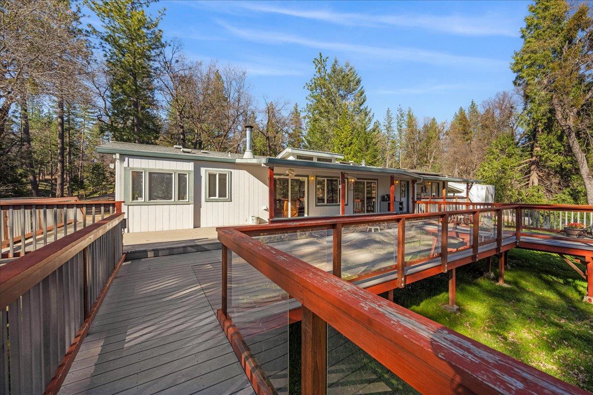 5351 Cosumnes Mine Road Somerset, CA 95684 - Photo 44 of 66 a balcony with wooden floor and fence next to a yard