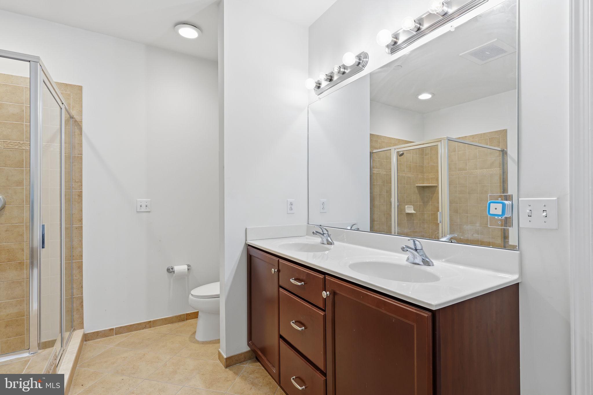556 Carson Terrace Huntingdon Valley, PA 19006 - Photo 16 of 42 a bathroom with a sink double vanity and a mirror