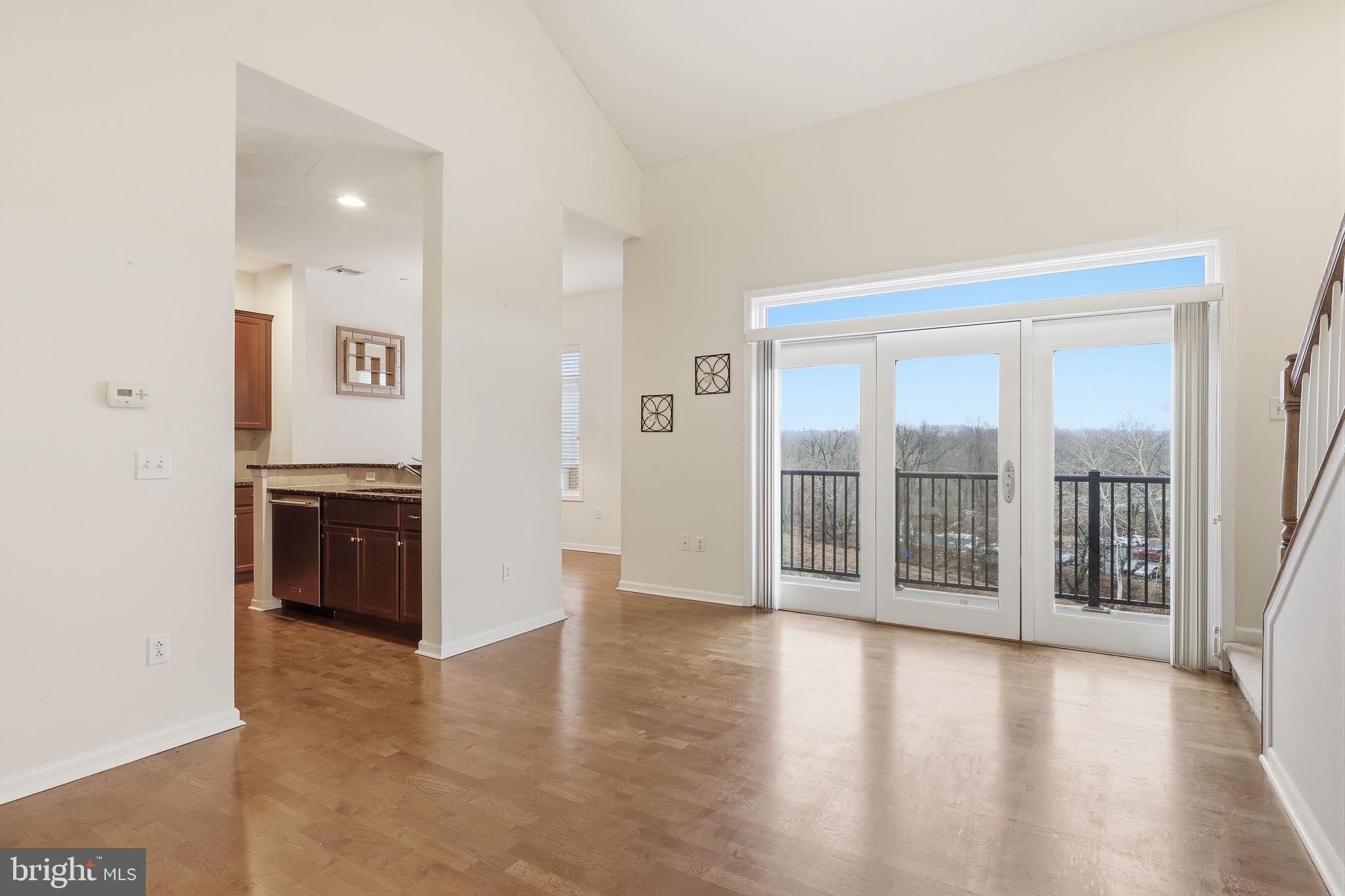 556 Carson Terrace Huntingdon Valley, PA 19006 - Photo 5 of 42 an empty room with wooden floor and windows