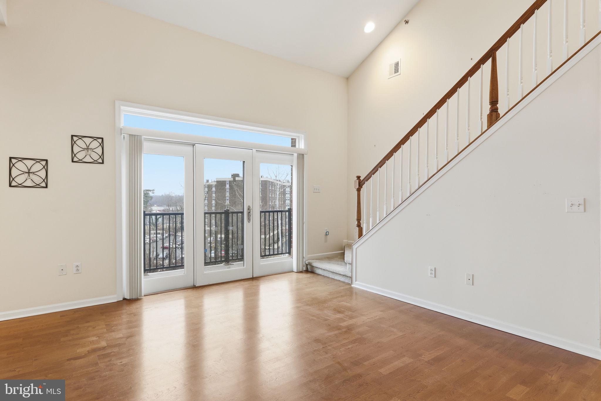 556 Carson Terrace Huntingdon Valley, PA 19006 - Photo 6 of 42 a view of an empty room with wooden floor and stairs