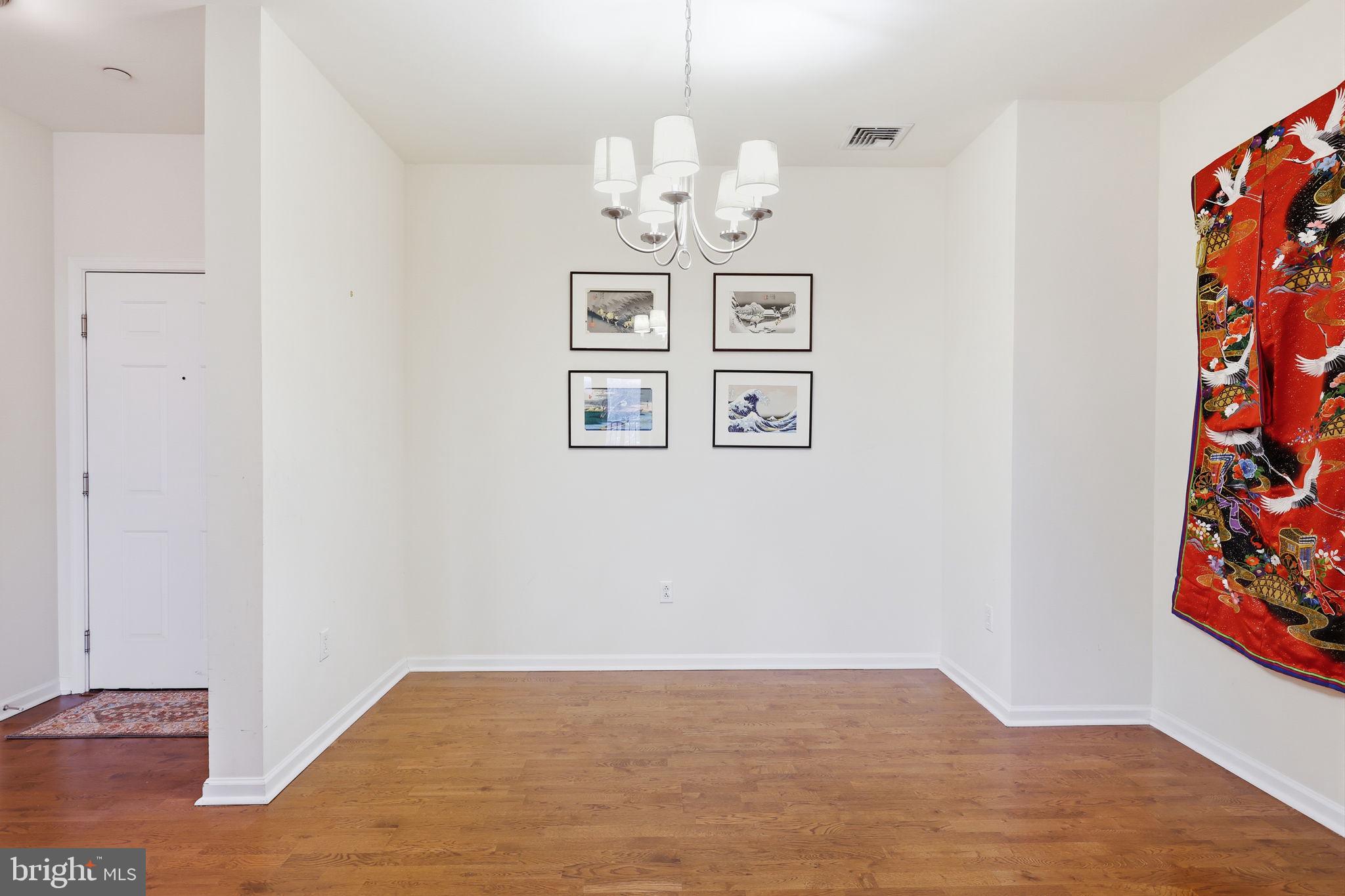 556 Carson Terrace Huntingdon Valley, PA 19006 - Photo 8 of 42 a view of a chandelier in a room with a chandelier fan and wooden floor