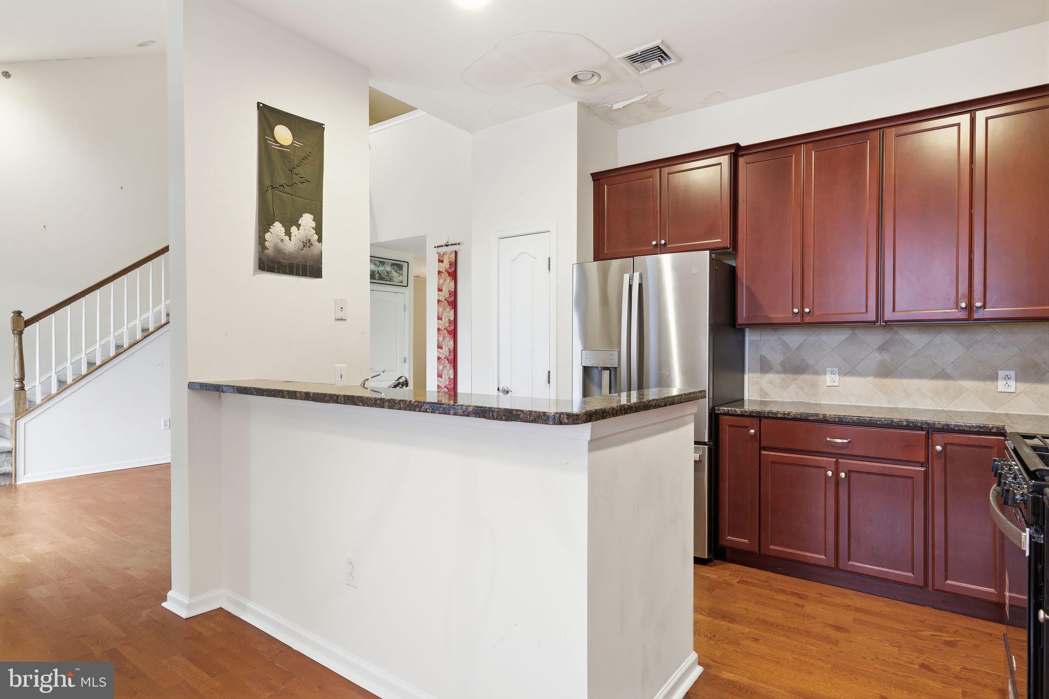 556 Carson Terrace Huntingdon Valley, PA 19006 - Photo 9 of 42 a kitchen with stainless steel appliances granite countertop a refrigerator and a stove top oven