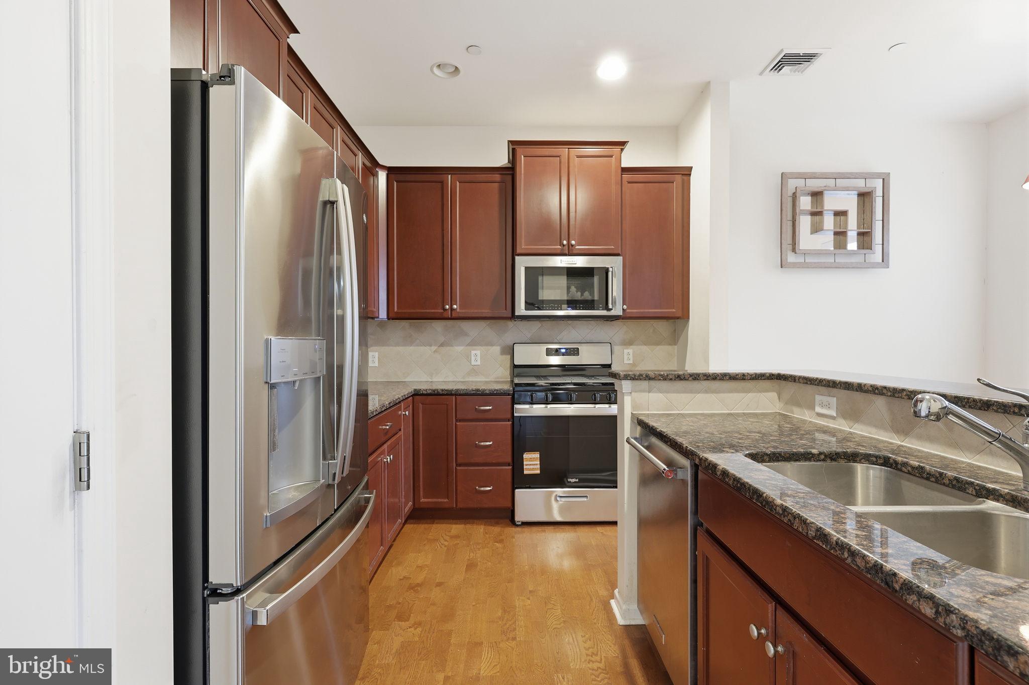 556 Carson Terrace Huntingdon Valley, PA 19006 - Photo 10 of 42 a kitchen with stainless steel appliances granite countertop a refrigerator sink and stove