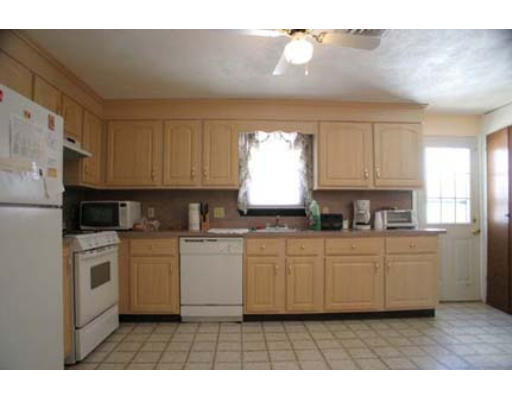 13 Rickey Drive Maynard, MA 01754 - Photo 7 of 15 a kitchen with stainless steel appliances granite countertop a stove a sink a refrigerator and white cabinets