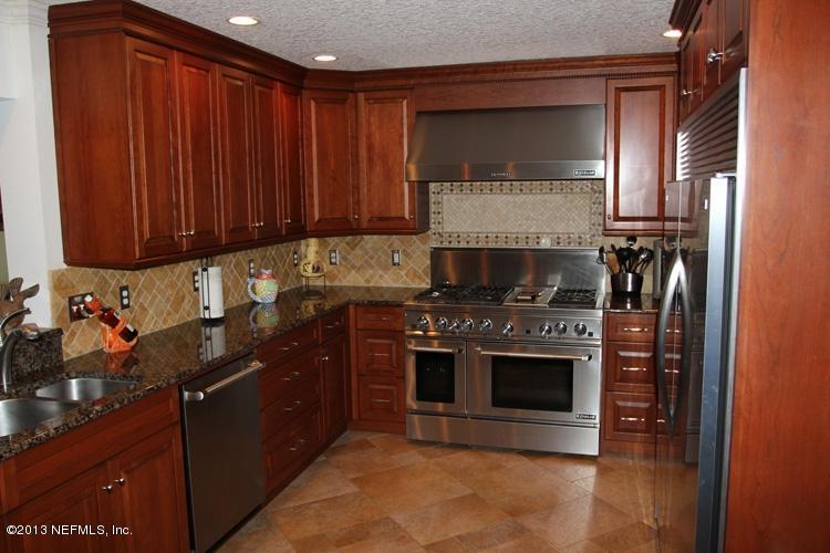 14320 Stacey Road Jacksonville, FL 32250 - Photo 23 of 35 a kitchen with stainless steel appliances granite countertop a stove a sink and a microwave