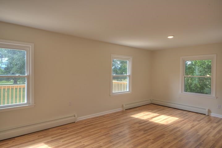 670 Rockfish Road Waynesboro, VA 22980 - Photo 11 of 58 an empty room with wooden floor and windows