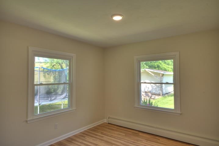 670 Rockfish Road Waynesboro, VA 22980 - Photo 13 of 58 an empty room with wooden floor and windows