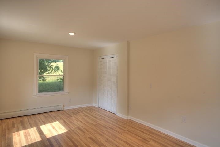 670 Rockfish Road Waynesboro, VA 22980 - Photo 39 of 58 an empty room with wooden floor and windows