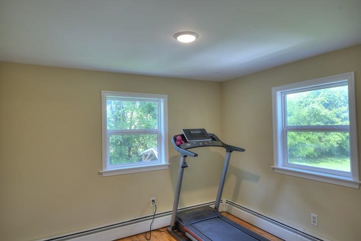 670 Rockfish Road Waynesboro, VA 22980 - Photo 48 of 58 a room with gym equipment on wooden floor and window