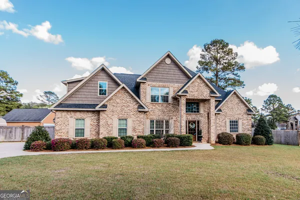a front view of a house with a yard