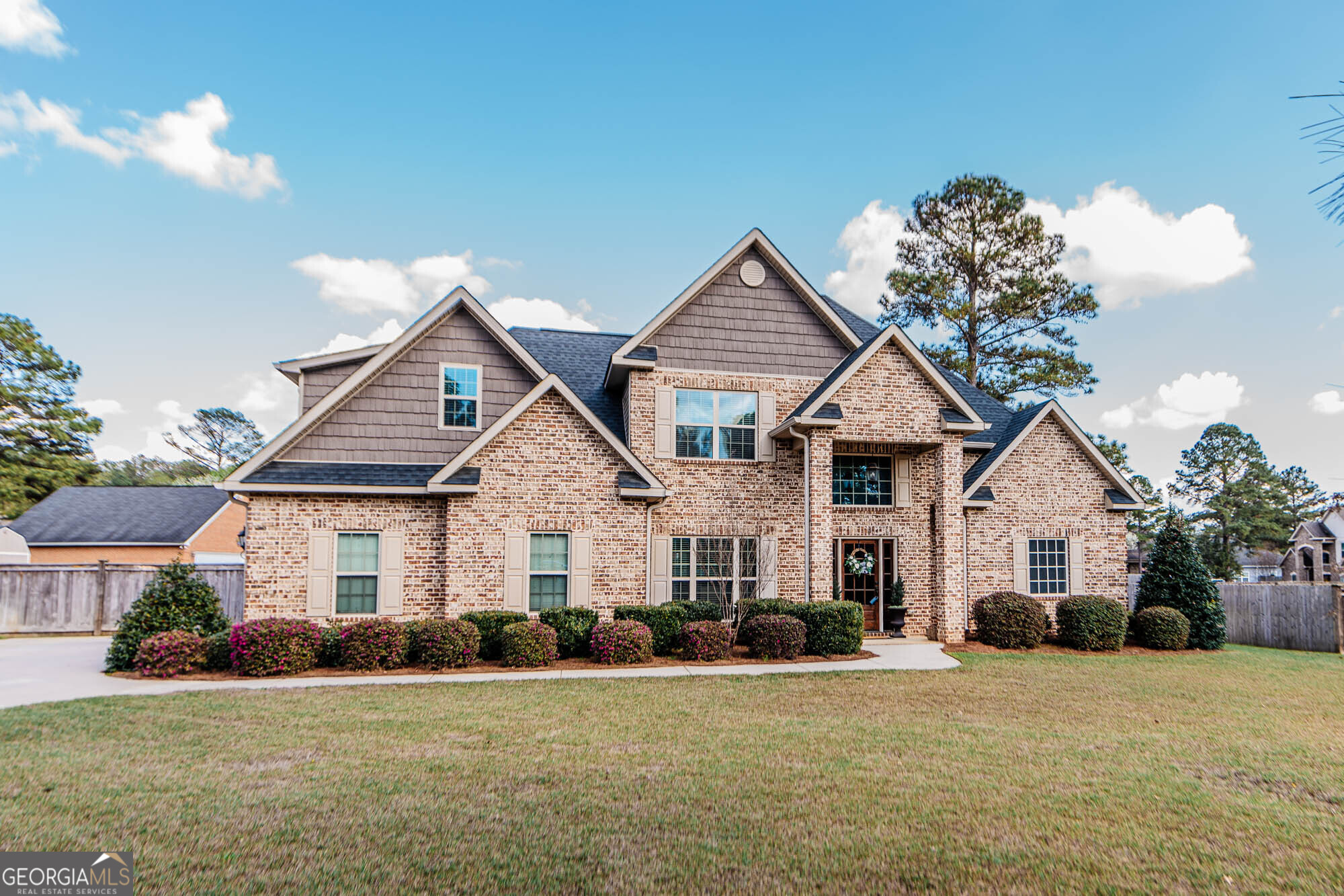 a front view of a house with a yard