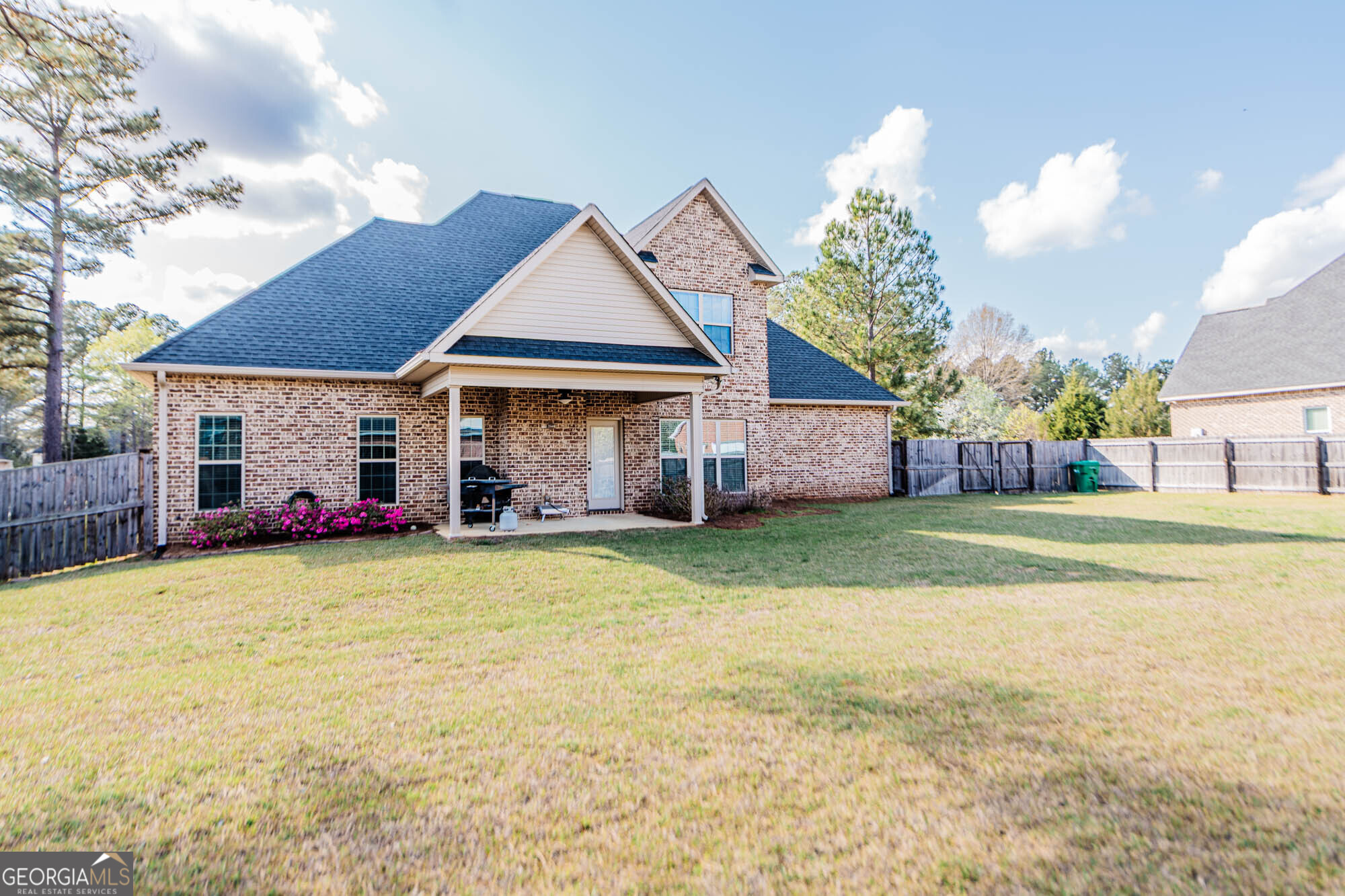 112 Bainbridge Lane Perry, GA 31069 - Photo 3 of 34 a front view of a house with a garden and deck