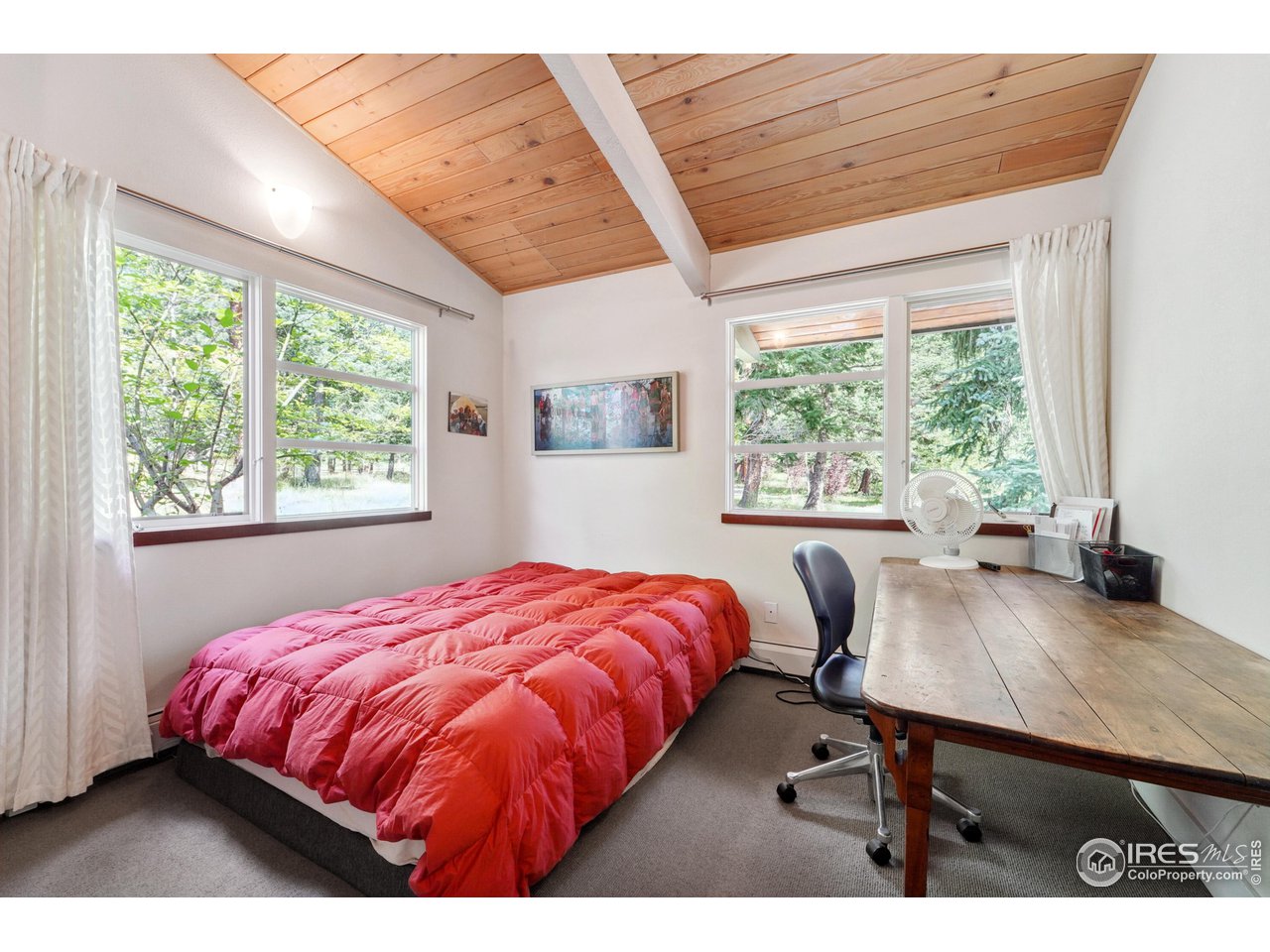 5055 Sugarloaf Road Boulder, CO 80302 - Photo 27 of 40 a bed sitting in a bedroom next to a window