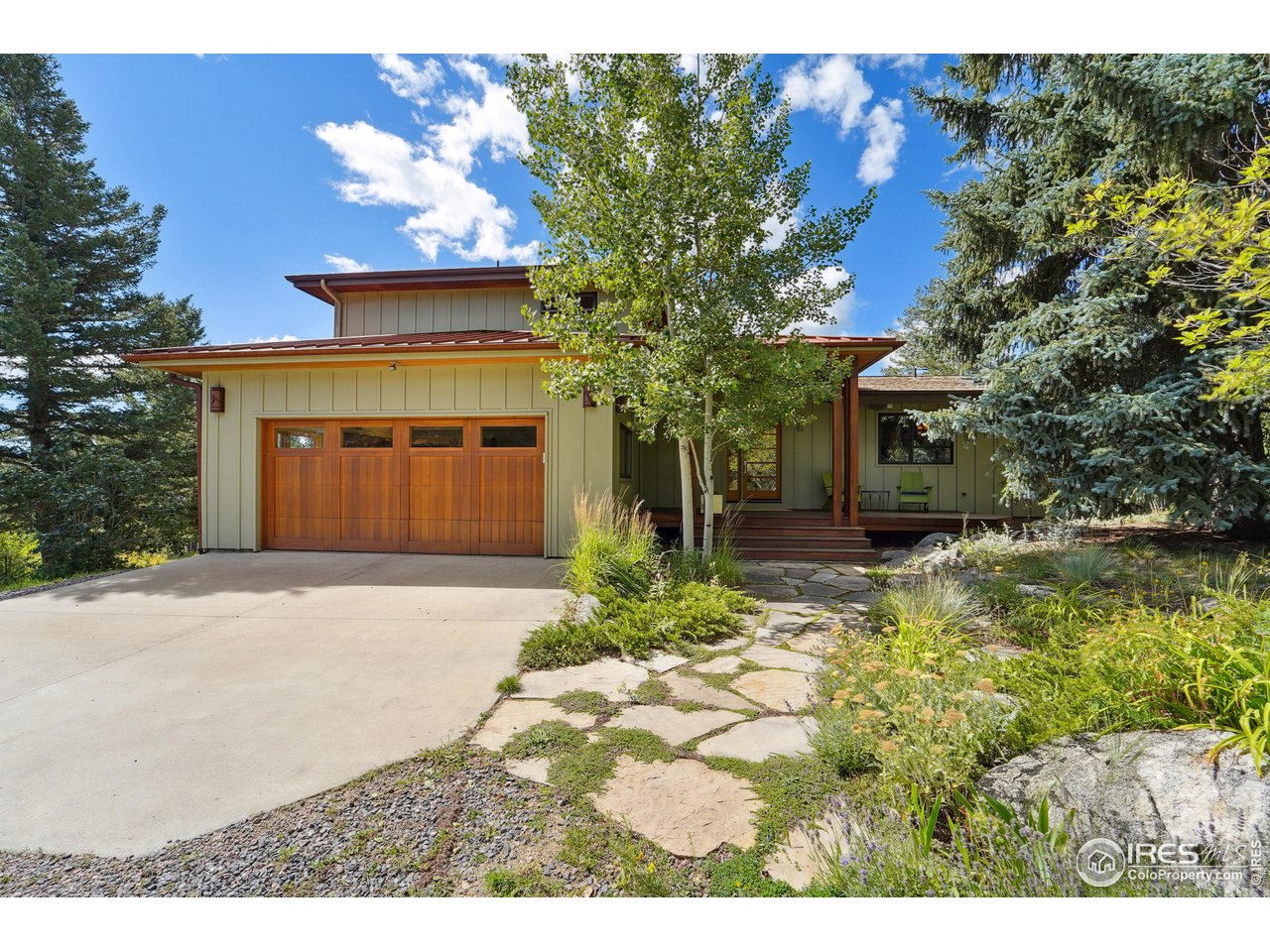 5055 Sugarloaf Road Boulder, CO 80302 - Photo 4 of 40 a front view of a house with a yard and garage