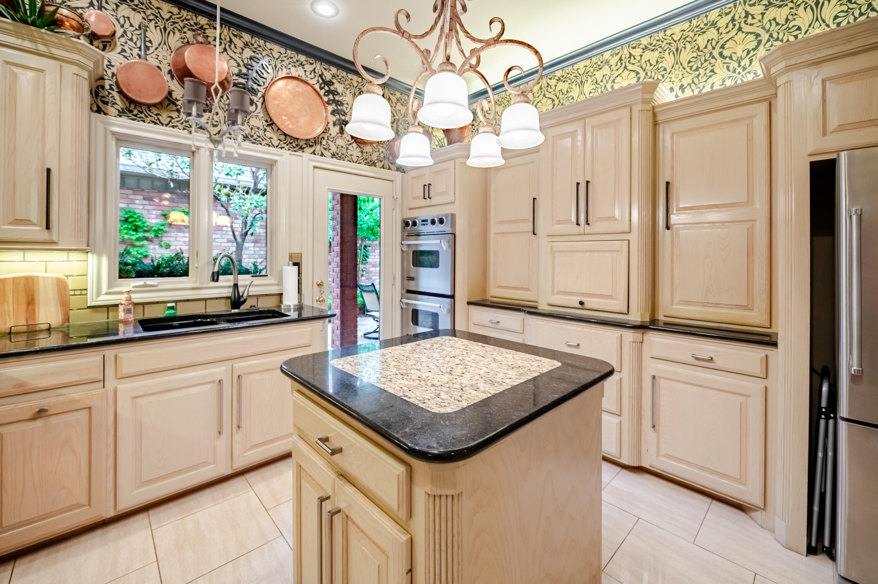 4226 97th Place Lubbock, TX 79423 - Photo 23 of 52 a kitchen with cabinets and chandelier