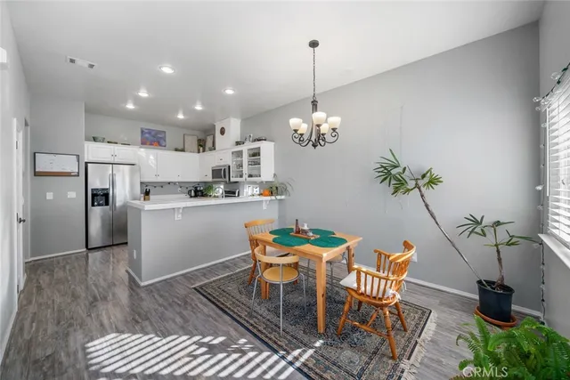 a dining room with furniture and a chandelier
