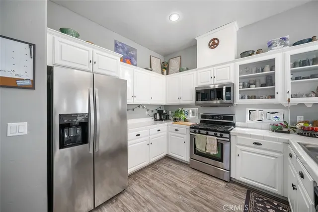a kitchen with stainless steel appliances a refrigerator sink and stove