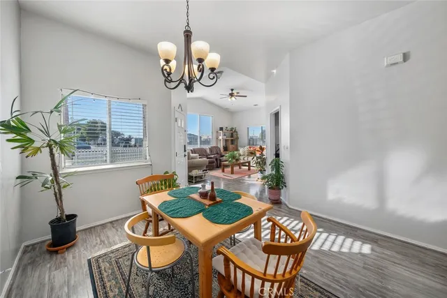 a view of a dining room with furniture wooden floor and chandelier