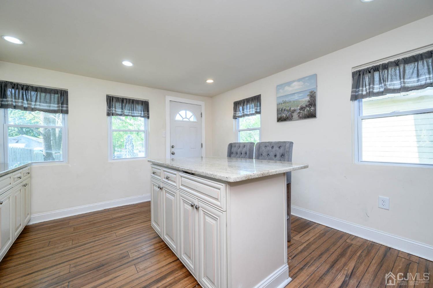 245 Washington Street Mount Holly, NJ 08060 - Photo 15 of 25 a kitchen with granite countertop a sink and wooden floor