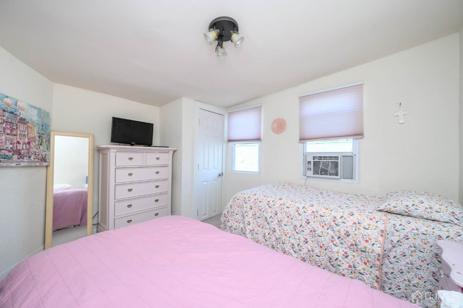 245 Washington Street Mount Holly, NJ 08060 - Photo 17 of 25 a bedroom with a bed and a television
