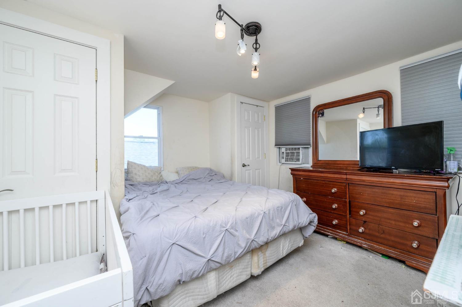 245 Washington Street Mount Holly, NJ 08060 - Photo 18 of 25 a bedroom with a bed and a flat screen tv