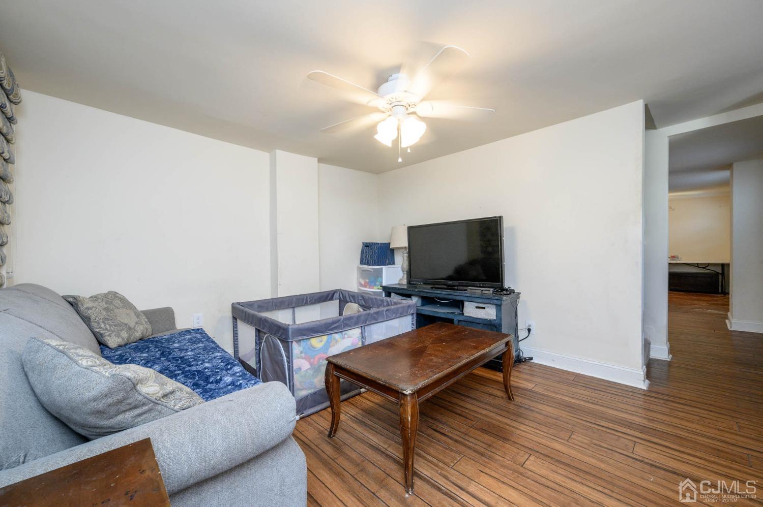 245 Washington Street Mount Holly, NJ 08060 - Photo 4 of 25 a living room with furniture and a flat screen tv
