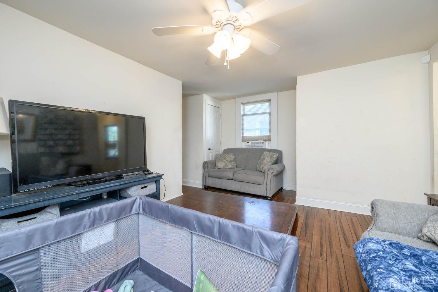 245 Washington Street Mount Holly, NJ 08060 - Photo 6 of 25 a living room with furniture and a flat screen tv