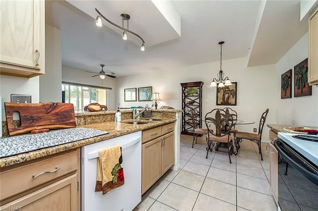 a kitchen with stainless steel appliances granite countertop sink stove and cabinets