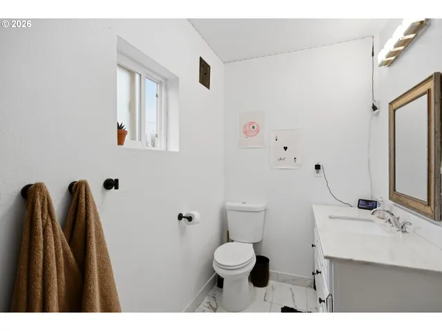 a bedroom with a bed and a wooden floor