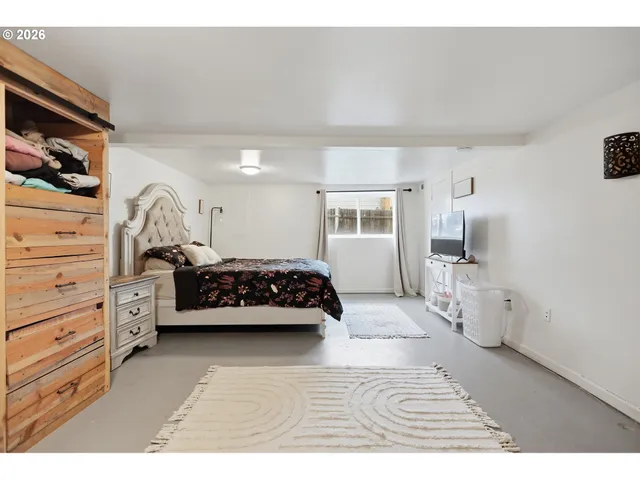 a bedroom with a bed and a couch