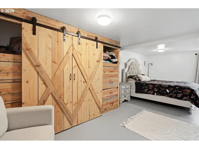 a bedroom with a bed and a desk