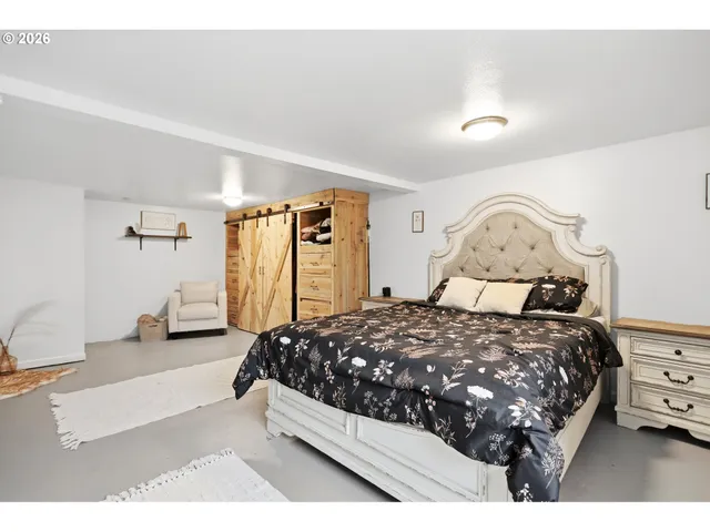 a bedroom with furniture and a large window