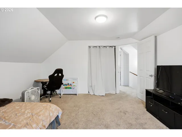 a living room with baby crib furniture and a window