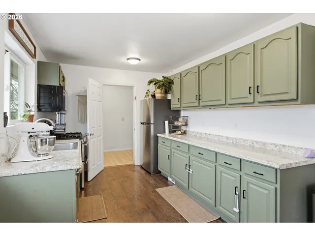 a kitchen with a sink cabinets and wooden floor