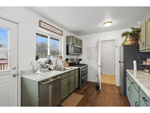 a kitchen with a sink stove and refrigerator