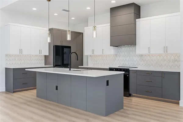 a kitchen with a sink cabinets and wooden floor