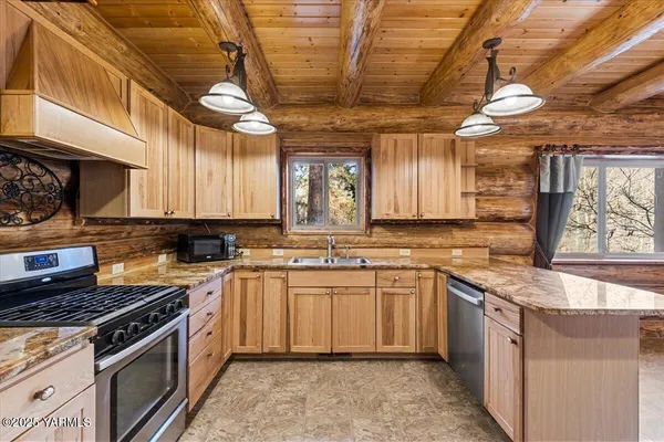 a kitchen with a sink stove and cabinets