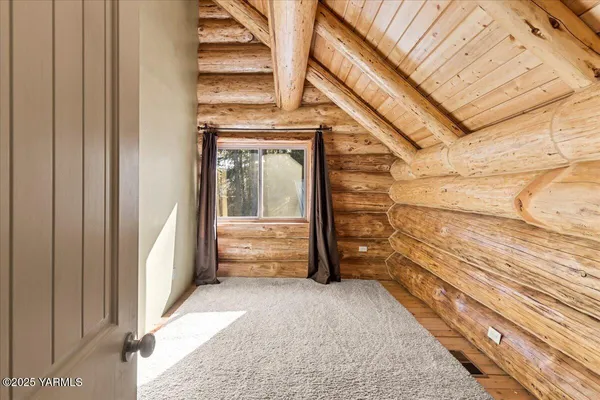 a view of walk in closet with clothes
