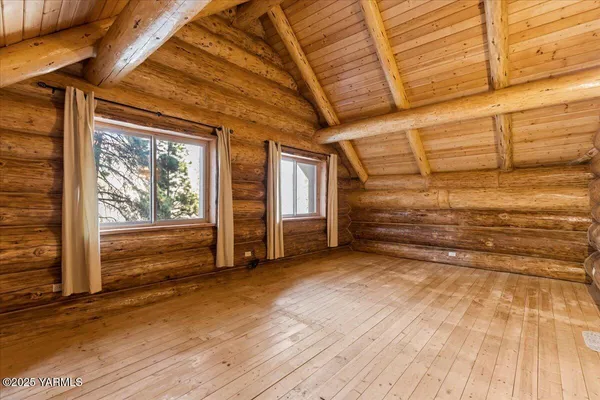 a view of balcony with wooden floor and bench