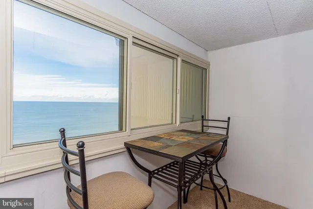 a bedroom with a bed and a lamp on the dresser