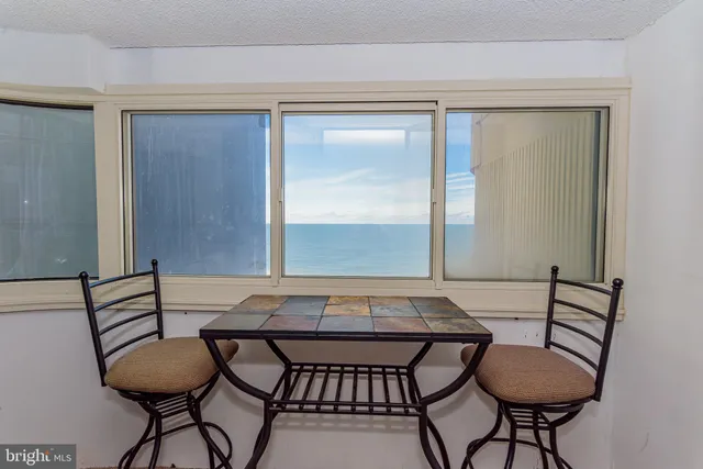 a view of a dining room with furniture and a window