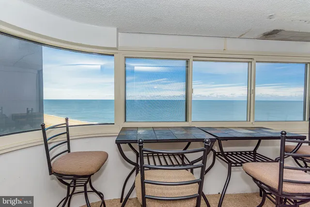 a living room with furniture a flat screen tv and a floor to ceiling window