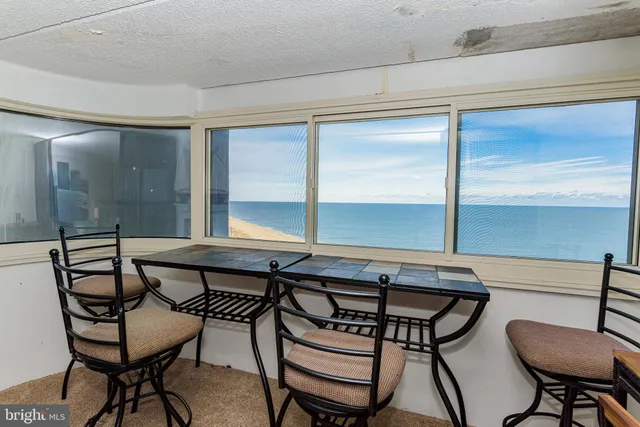 a view of a room that has a table and chairs in it