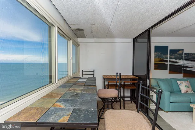 a view of a room that has a table and chairs in it